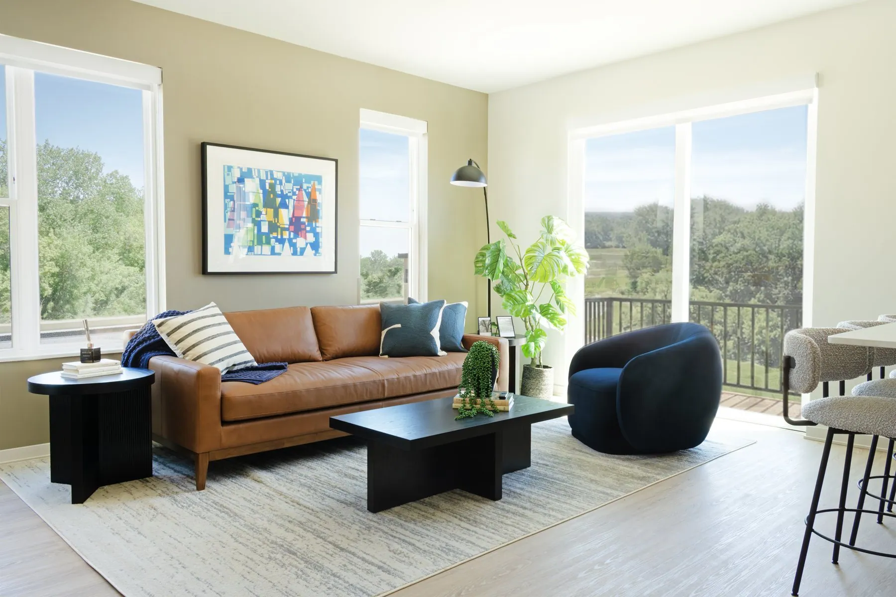 Living room with balcony view at Inspire Prairie Springs