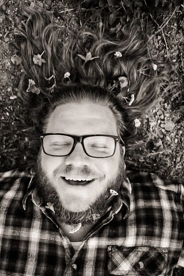 Team member lying in the grass, laughing