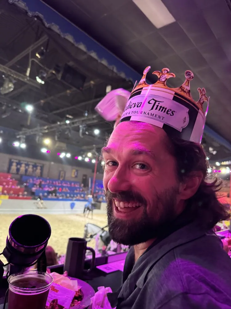 Team member in a paper crown at Medieval Times