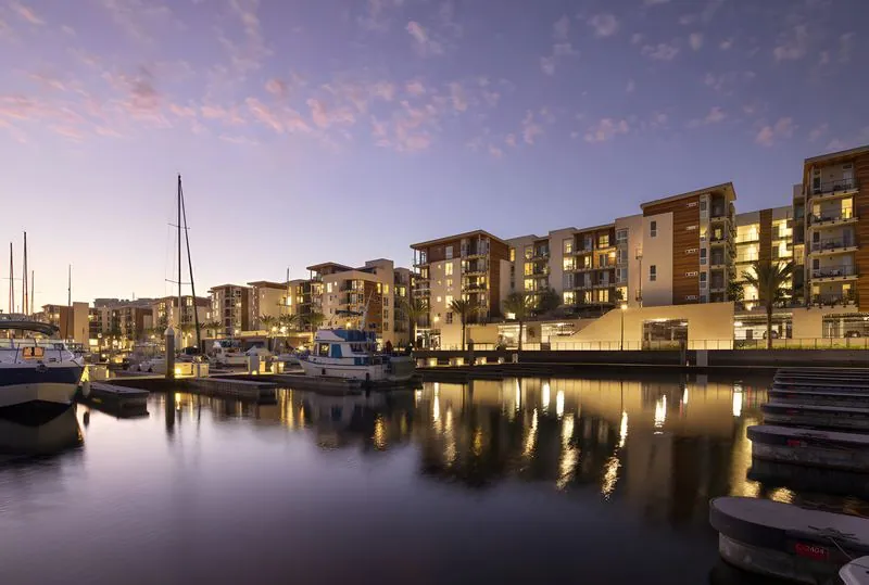 Waterfront apartment community at dusk
